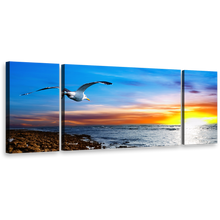 Load image into Gallery viewer, Bird Sunset Wall Art, Dramatic Clouds in Orange Sky Canvas Print, Blue Sky Bird Soaring Triptych Canvas Set
