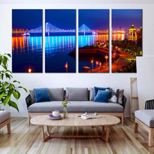 Load image into Gallery viewer, city  beach  wall  art  blue  bay  cross  sea  bridge  night  lights  water  reflection  4  piece  multi  canvas  print In Living Room
