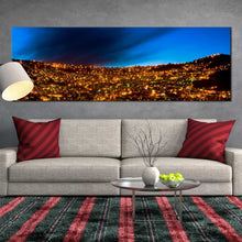 Load image into Gallery viewer, golden  city  lights  canvas  wall  art  la  paz  bolivia  s  skyline  amidst  majestic  mountains  panoramic  canvas  print In Living Room
