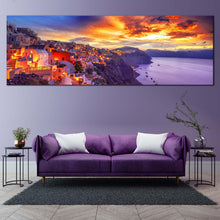 Load image into Gallery viewer, oia  s  purple  dawn  panoramic  canvas  of  greece  houses  by  the  aegean  sea  with  dramatic  yellow  clouds  wall  art In Living Room
