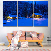 Load image into Gallery viewer, snowy forest serenity canvas blue nighttime trees in 3 panels with yellow cabin lights canvas wall art In Living Room
