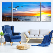 Load image into Gallery viewer, sunset  breeze  bird  canvas  wall  art  clouds  in  orange  sky  canvas  set  bird  soaring  in  blue  sky  triptych  canvas  print In Living Room
