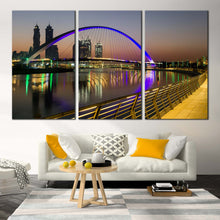 Load image into Gallery viewer, tolerance bridge canvas print iconic 3 piece canvas with blue dubai bridge reflection over grey sky wall art In Living Room
