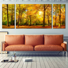 Load image into Gallery viewer, vivid  autumn  forest  triptych  wall  art  green  trees  orange  fields  and  yellow  sun  casting  canvas  print In Living Room
