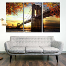 Load image into Gallery viewer, Brooklyn NYC Bridge Dramatic Sunset 3 pc. canvas artwork In Living Room
