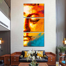 Load image into Gallery viewer, Buddha Face Canvas Wall Art Golden Buddha Close Up Triptych Canvas Print Yellow Blue Buddha Abstract 3 Piece Canvas In Living Room
