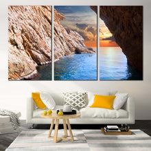 Load image into Gallery viewer, Cave Ocean Canvas Wall Art Yellow Cloudy Sunset Sky Canvas Artwork Brown Ocean Rocks  3 Piece Canvas Print In Living Room
