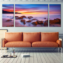 Load image into Gallery viewer, Cloudy  Sky  Canvas  Wall  Art  Boulders  Yellow  Seascape  Canvas  Print  Purple  California  Coast  Ocean  Rocks 3  Piece  Canvas In Living Room

