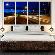 Load image into Gallery viewer, Moving car light trail through twilight city roads 4 piece canvas artwork For Bedroom
