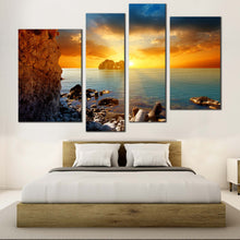 Load image into Gallery viewer, Ocean Rocks Canvas Wall Art Dramatic Yellow Cloudy Sunset Sky Multi Panel Canvas Blue Sea Ocean Boulders  4 Piece Canvas Print In Bedroom
