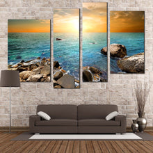 Load image into Gallery viewer, Ocean Sunset Canvas Wall Art Blue Ocean Rocks Canvas Print Blue Stony Beach  4 Piece Canvas Yellow Cloudy Sky Canvas Set 
