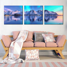 Load image into Gallery viewer, aurora  borealis  canvas  wall  art  northern  lights  white  mountain  ocean  multiple  canvas  blue  sky  lofoten  islands  sea  3  piece  canvas  print In Living Room
