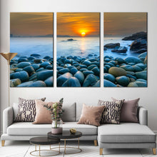 Load image into Gallery viewer, beautiful sunrise canvas print vietnam orange ocean sky 3 piece canvas wall art quy nhon bay stony beach canvas set blue ocean rocks multi canvas In Living Room
