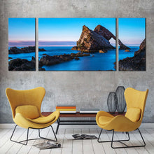 Load image into Gallery viewer, bow  fiddle  canvas  print  blue  sky  ocean  coast  3  piece  canvas  wall  art  brown  ocean  rocks  triptych  multiple  canvas In Living Room
