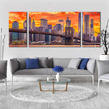 Load image into Gallery viewer, brooklyn  bridge  canvas  wall  art  brown  new  york  city  canvas  set  nyc  orange  dramatic  clouds  3  piece  canvas  print  wall  street  skyline  multi  canvas In Living Room
