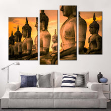 Load image into Gallery viewer, buddha park canvas print thailand brown buddha statue 4 piece canvas wall art yellow sky buddha canvas set in living room
