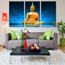 Load image into Gallery viewer, buddha statue canvas wall art blue lighting background gold buddha 3 piece canvas print big yellow lord buddha triptych multiple canvas In Living Room
