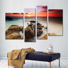 Load image into Gallery viewer, cloudy sea canvas wall art red orange sky ocean canvas print brown ocean rocks boulders 4 piece canvas for your living room 
