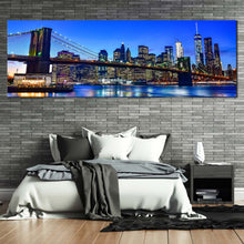 Load image into Gallery viewer, manhattan  cityscape  canvas  wall  art  black  brooklyn  bridge  city  reflection  panoramic  canvas  print  blue  sky  new  york  city  canvas  artwork In Bedroom
