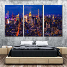 Load image into Gallery viewer, new york canvas wall art yellow city lights midtown manhattan 3 piece canvas print nyc at blue night triptych multiple canvas In Bedroom
