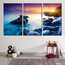 Load image into Gallery viewer, ocean boulders canvas wall art dramatic yellow sunset sky canvas print crimea ukraine blue ocean rocks 3 piece canvas set
