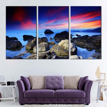 Load image into Gallery viewer, ocean rocks canvas wall art dramatic red sky seascape canvas print blue sea stony beach ocean 3 piece multiple canvas In Living Room
