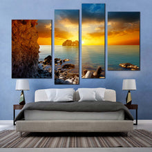 Load image into Gallery viewer, ocean rocks canvas wall art dramatic yellow cloudy sunset sky 4 piece multiple canvas blue sea ocean boulders canvas print for bedroom
