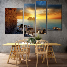 Load image into Gallery viewer, ocean rocks canvas wall art dramatic yellow cloudy sunset sky 4 piece multiple canvas blue sea ocean boulders canvas print for your living room 
