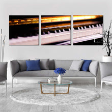 Load image into Gallery viewer, piano  lesson  canvas  print  orange  piano  close  up  3  piece  multi  canvas  artwork  white  piano  keyboard  notes  canvas  wall  art In Living Room
