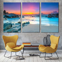 Load image into Gallery viewer, stony beach canvas wall art yellow sky ocean rocks sea 3 piece canvas print blue ocean water triptych multi canvas In Living Room
