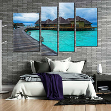 Load image into Gallery viewer, water villa canvas wall art blue ocean wooden bridge 4 piece canvas print brown hotel on water multiple canvas in bedroom
